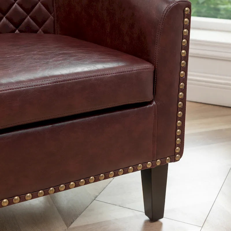 Gepolsterter Clubsessel aus Leder im Fassondesign mit Ziernägeln