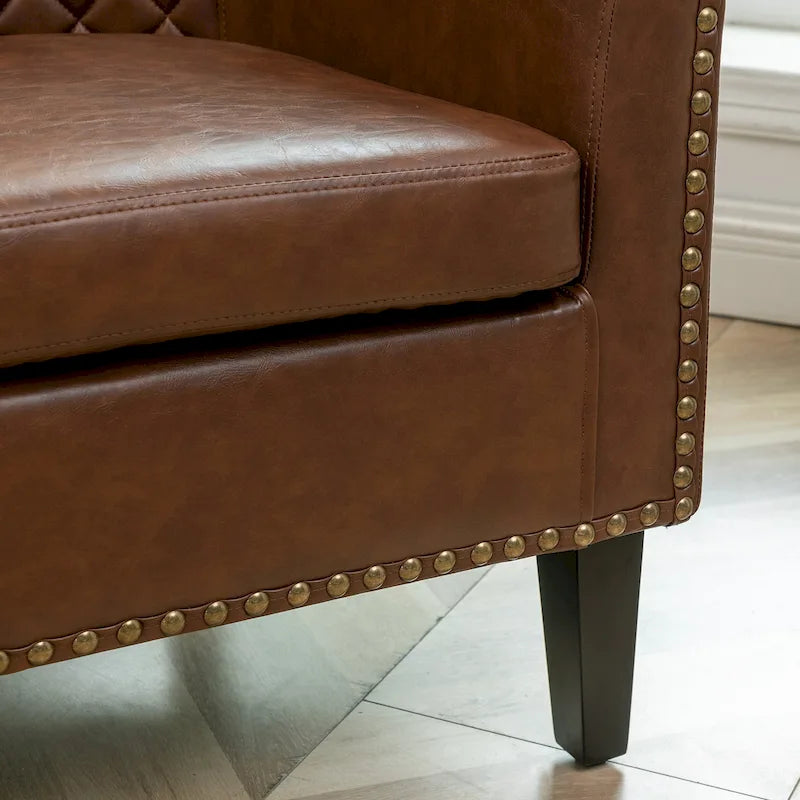 Gepolsterter Clubsessel aus Leder im Fassondesign mit Ziernägeln
